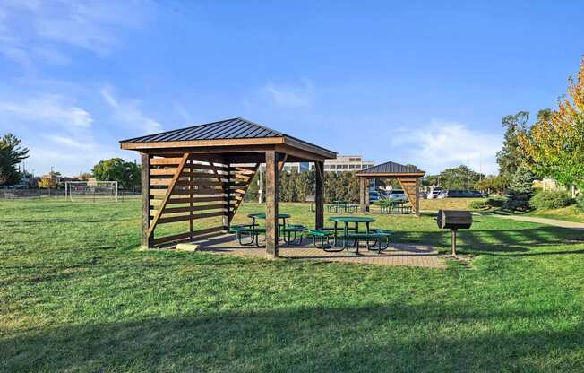 a picnic table with a pavilion in a park