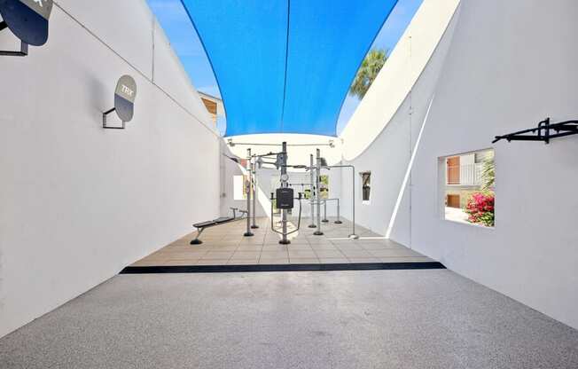 a gym with white walls and a blue ceiling