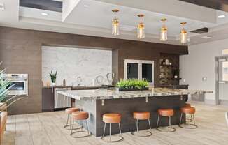 A kitchen with a bar area and stools.