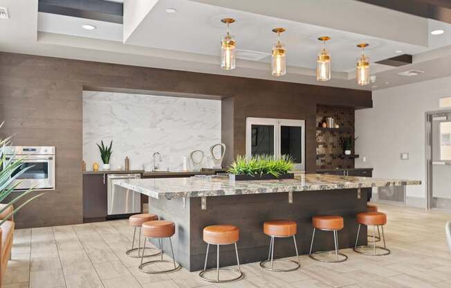 A kitchen with a bar area and stools.