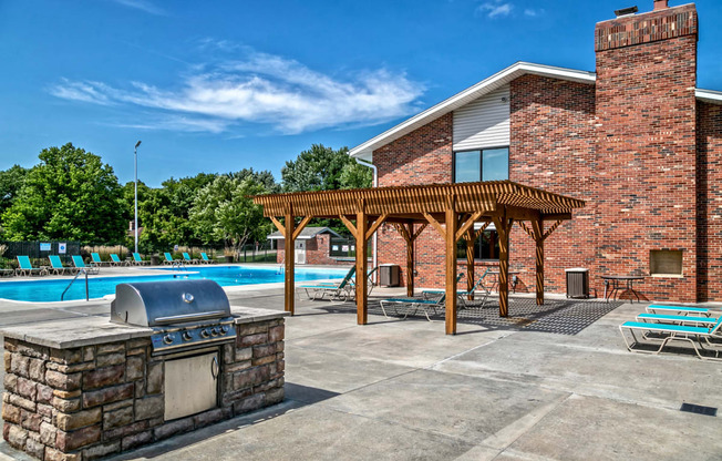 Olympic sized swimming pool with community grill at Club at Highland Park Apartments, Omaha, NE