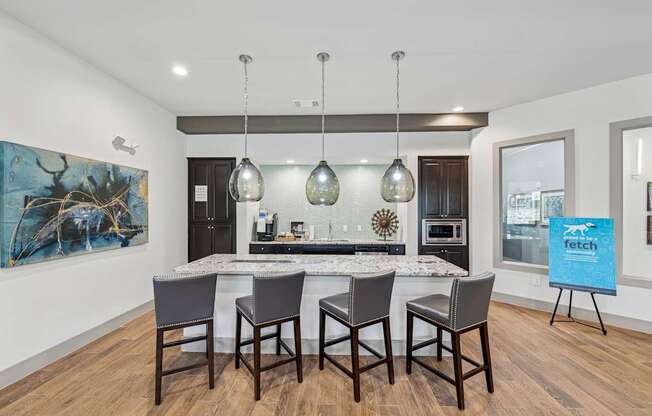 A kitchen with a dining table and chairs.