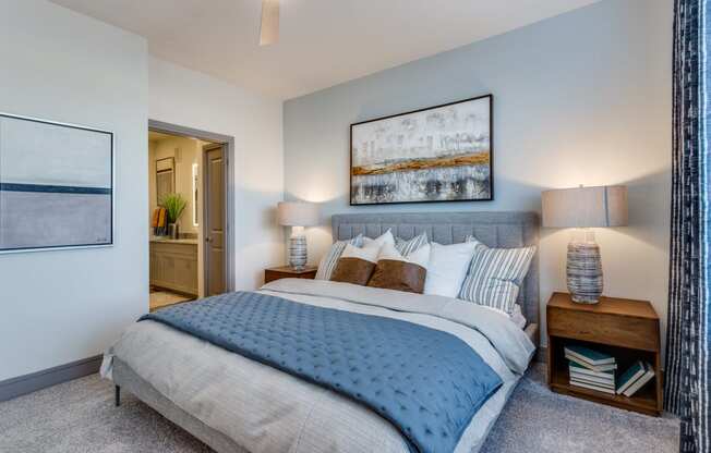 a bedroom with a large bed and a view of the bathroom