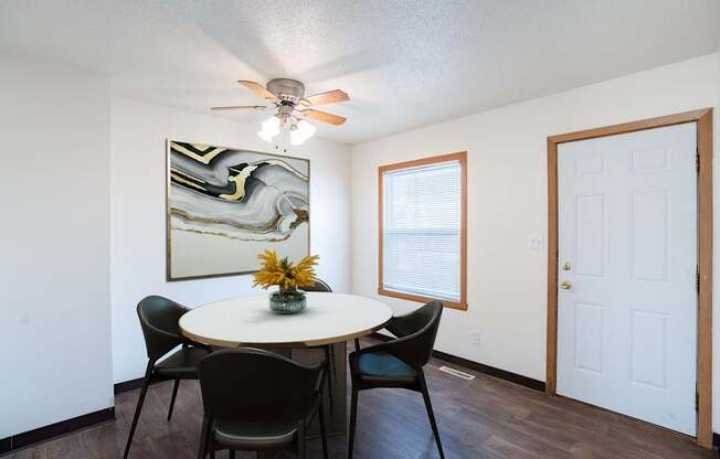 A dining room with a round table and chairs. West Fargo, ND Sheyenne Terrace Townhomes