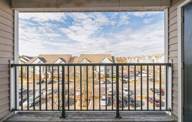 a balcony with a view of a parking lot