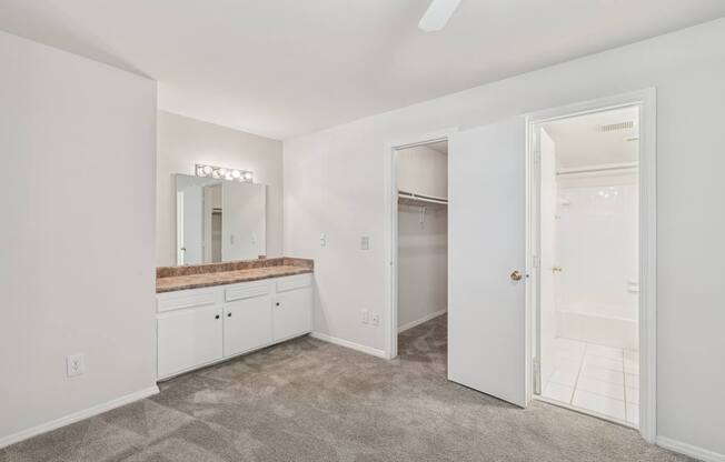 A room with a vanity and a mirror.