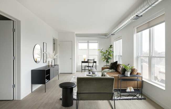 a living room with white walls and hardwood floors