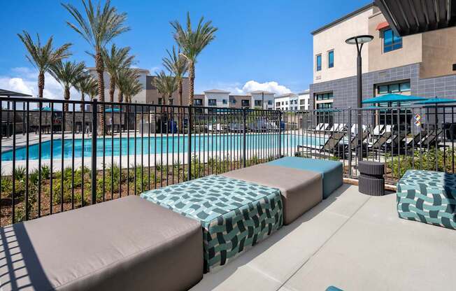 A pool area with a black fence and a blue pool.