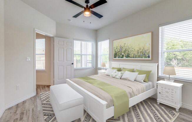 a bedroom with a large bed and a ceiling fan