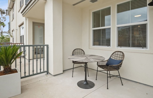 a patio with a table and chairs on a balcony