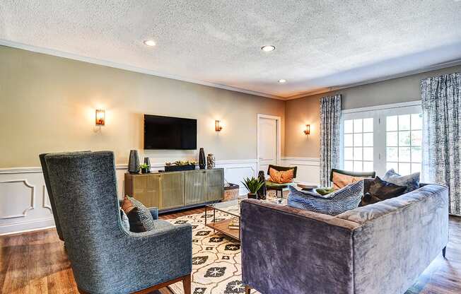 Clubhouse lounge at Ashton Brook Apartments, featuring comfortable seating and a TV.