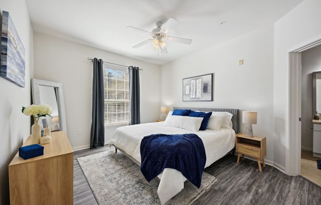 a bedroom with a large bed and a ceiling fan