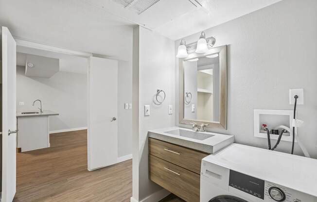 A white bathroom with a washer and dryer.
