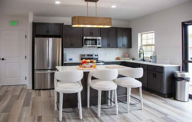 A kitchen with a white table and chairs at Evergreen Luxury Apartments, Merrillville, Indiana