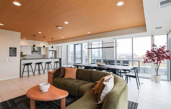 A modern living room with a green couch and a wooden table.