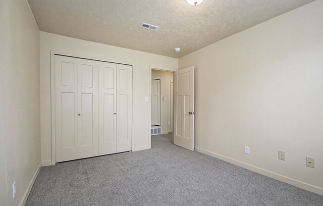 bedroom with a large closet and carpeting at Old Farm Apartments, Elkhart, Indiana