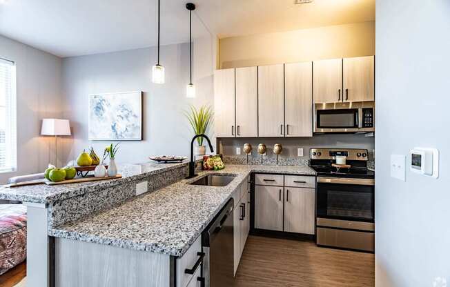 A kitchen with granite countertops and stainless steel appliances.