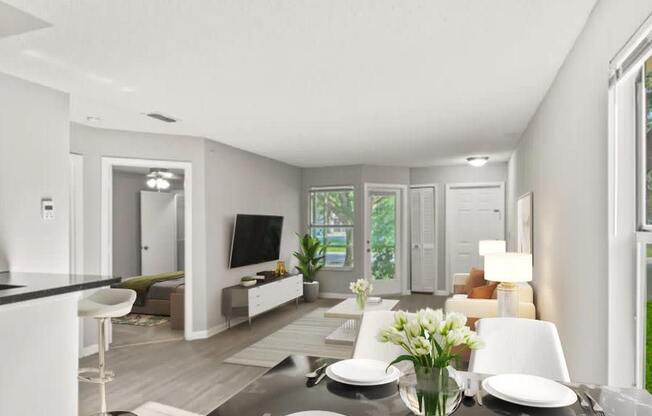 A dining room table with plates and a vase of flowers on top of it at Aqua Bay Apartments in Naples, FL 34116