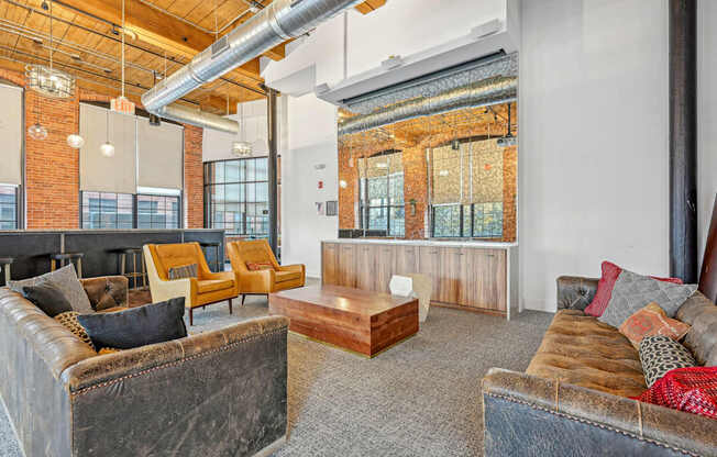 a living room with couches and chairs and a table