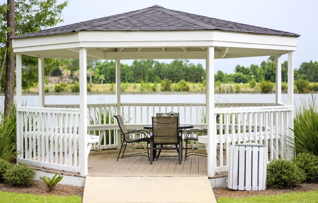 a gazebo with a table and chairs on it