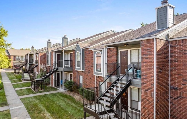 a row of brick apartment buildings with stairs