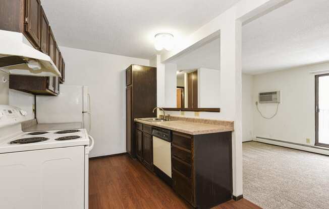 Fridley, MN Georgetown Apartments. A kitchen with white appliances and a wooden floor