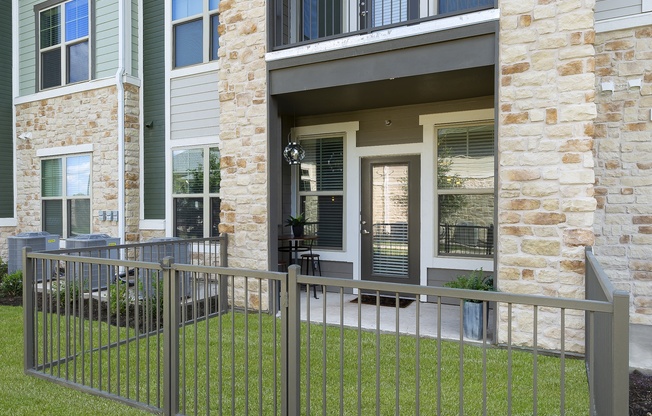 a metal fence in front of an apartment building at North Creek, Texas, 78634