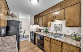 a kitchen with a sink and a refrigerator