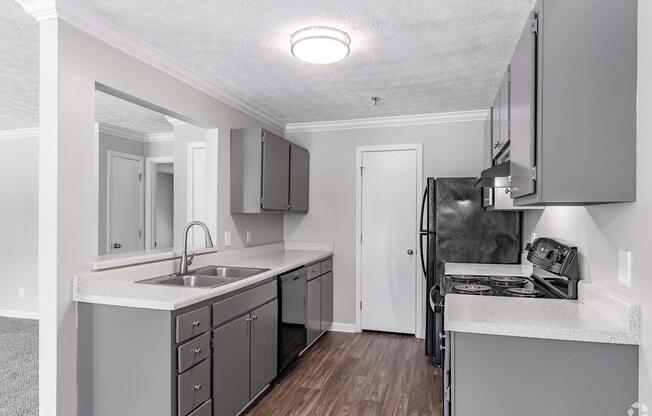 a kitchen with a sink and a refrigerator