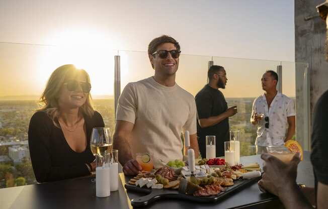 a group of people sitting at a table with a tray of food at AVE Phoenix Sky, Phoenix, Arizona