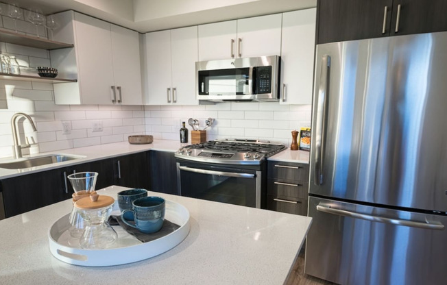 Our kitchens feature high-end finishes including stainless steel appliances and quartz countertops