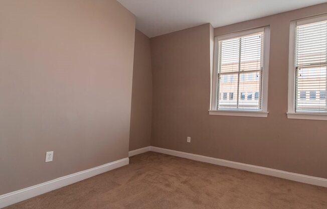 Bedroom with beige walls and carpeting