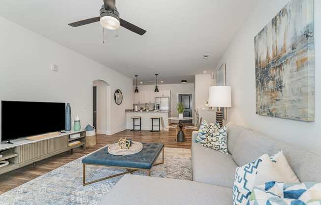 a living room with a couch and a coffee table in front of a tv