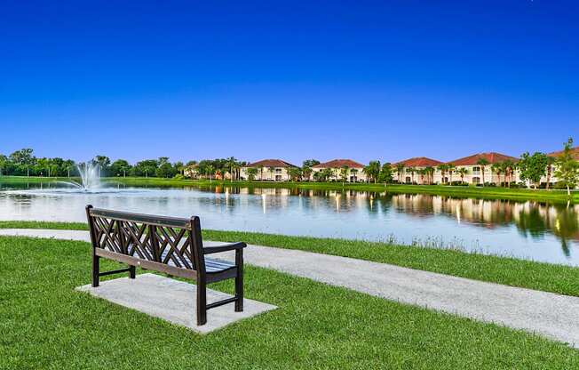 A park bench overlooking the water on a walking path at Bay Breeze apartments in Fort Myers, Florida