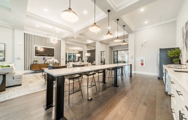 a large kitchen with a long island with bar stools