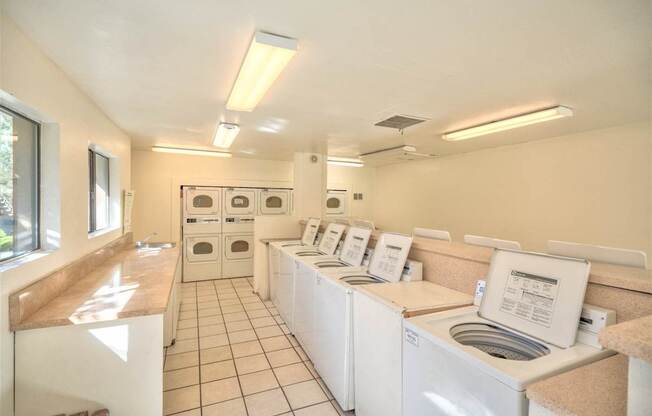 A laundromat with rows of washers and dryers.