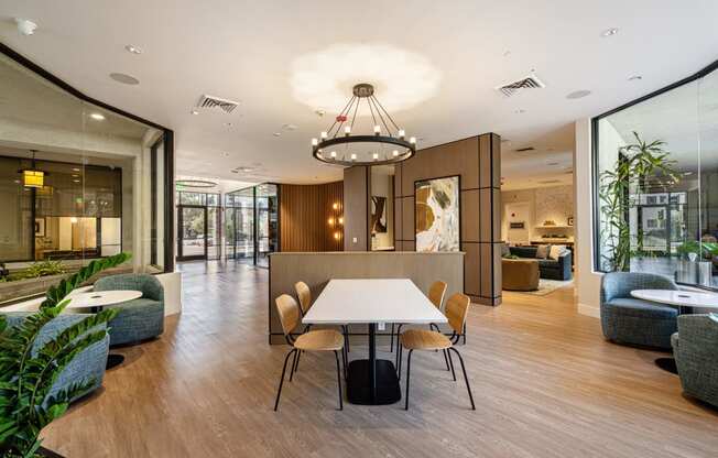 a large dining room with a white table and chairs