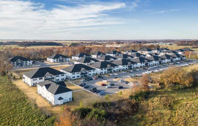 an aerial view of a group of houses in a parking lot