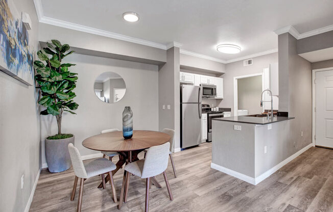 a kitchen and dining room with a table and chairs