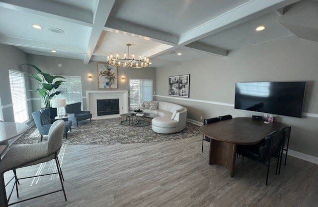 a living room with a tv and a table