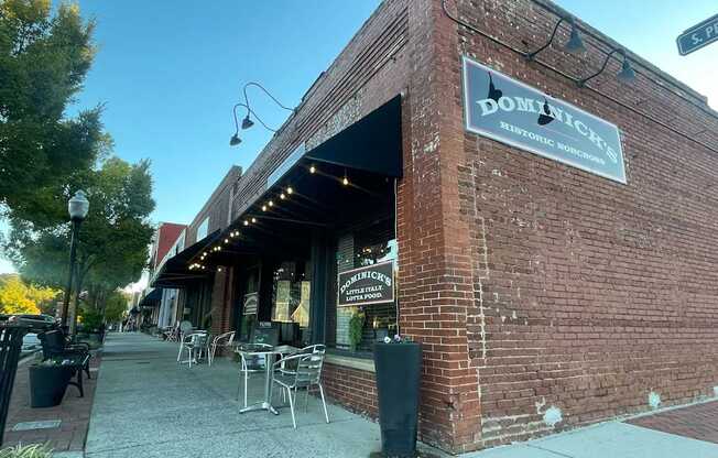 A brick building with a sign that says Dominick's on it.