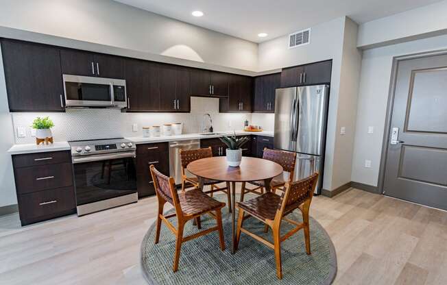 Eat-In Kitchen With Dining Room Table, Black Cabinets, White Countertops, And Stainless-Steel Appliances. at Bayswater Apartments, Burlingame