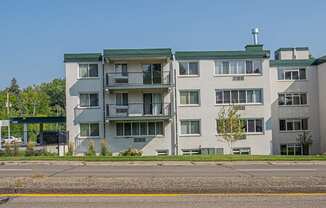 an image of an apartment building on the side of the street