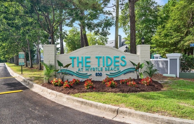 the tides sign at the entrance to the tidelands park