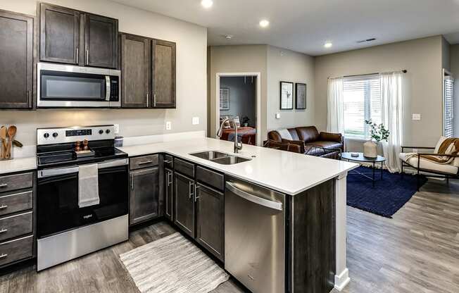 Kitchen with dark cabinets and a white counter tops at Hanover Flats in Bennington, NE