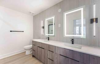 a bathroom with two sinks and a toilet