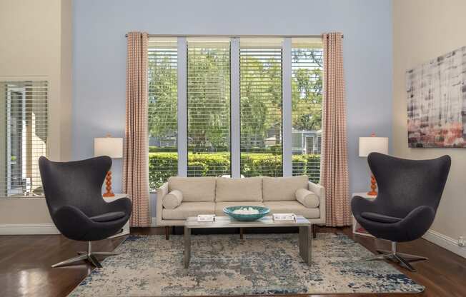 a living room with a couch and two chairs