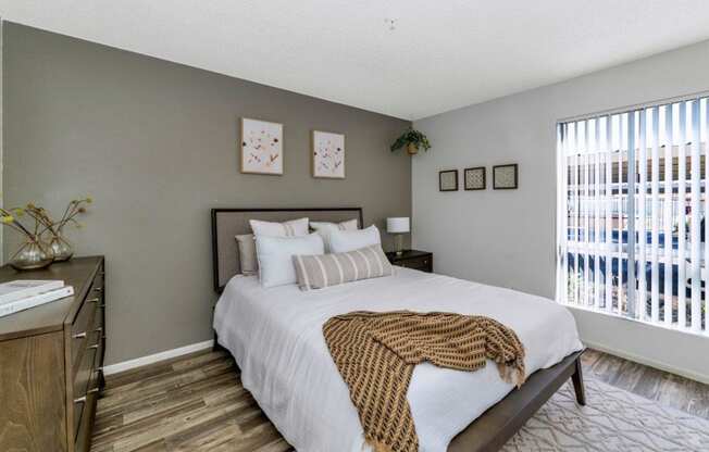 a bedroom with a large bed and a window