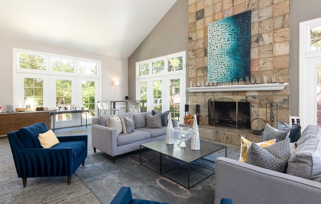 a living room with couches and chairs and a fireplace