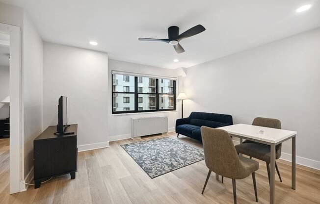 a living room with a couch and a table with chairs